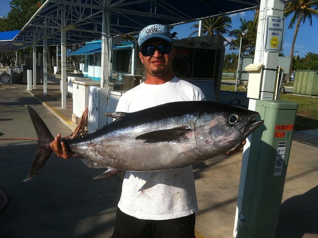 Angler with a blackfin tuna caught aboard Spellbound, Miami