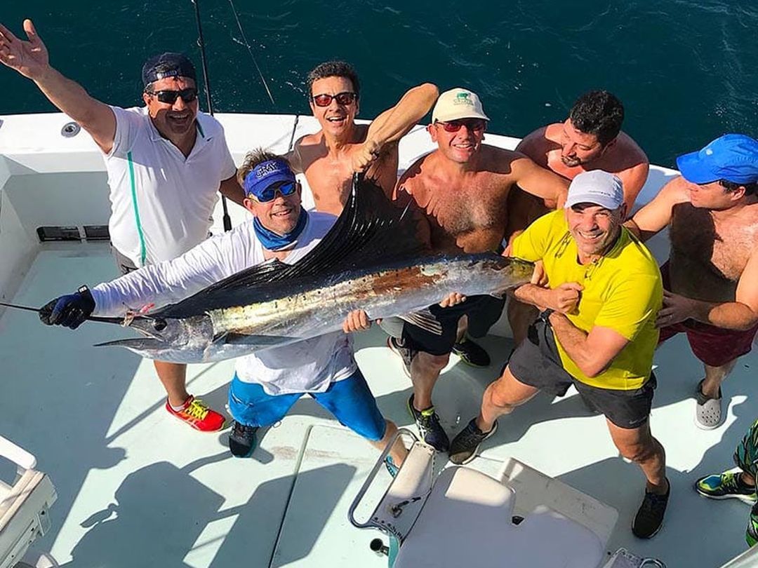 Group of anglers with a sailfish caught aboard Spellbound, Miami