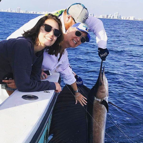 Anglers with a sailfish on a three quarter day charter aboard Spellbound, Miami