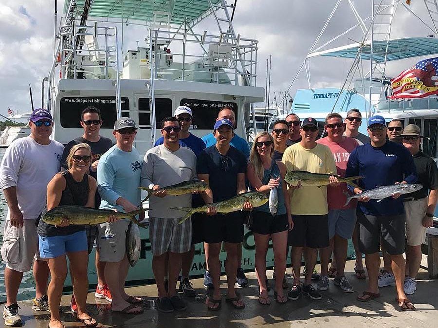 Large group with their catch dockside in front of Spellbound, Haulover Marina