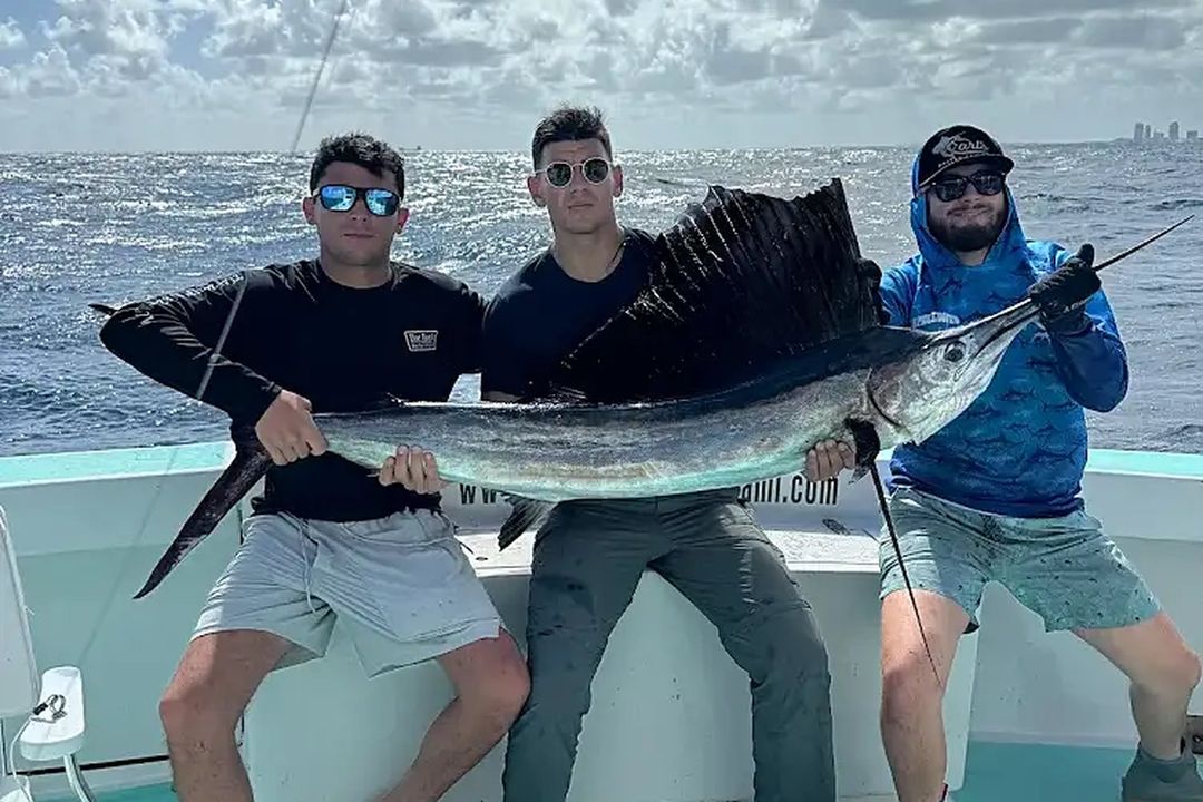 A bachelor party group with a sailfish aboard Spellbound, Miami