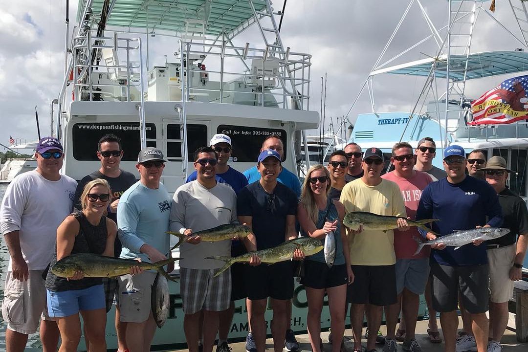 A corporate group with their catch aboard Spellbound, Miami