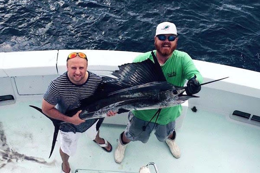 Anglers with a sailfish on a full day charter aboard Spellbound, Miami