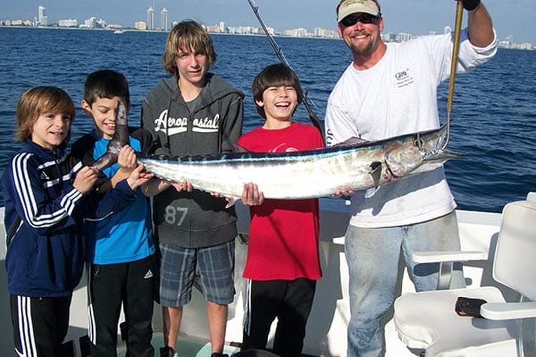 Young anglers with a wahoo on a three quarter day charter aboard Spellbound, Miami