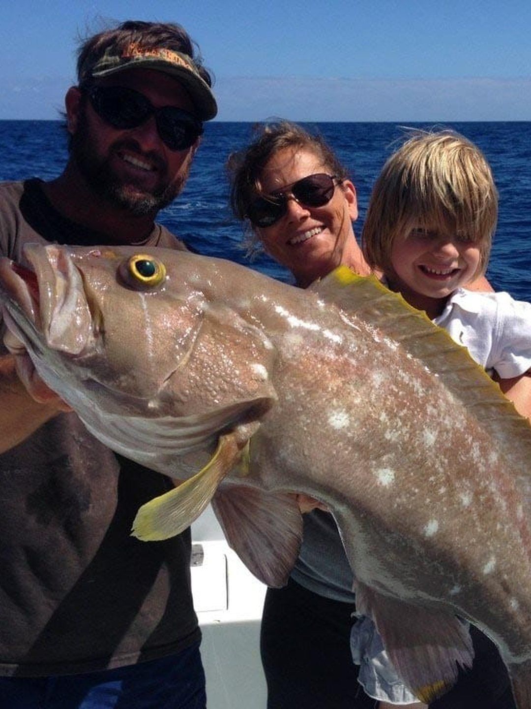 Family with a large deep-water grouper caught deep dropping off Miami